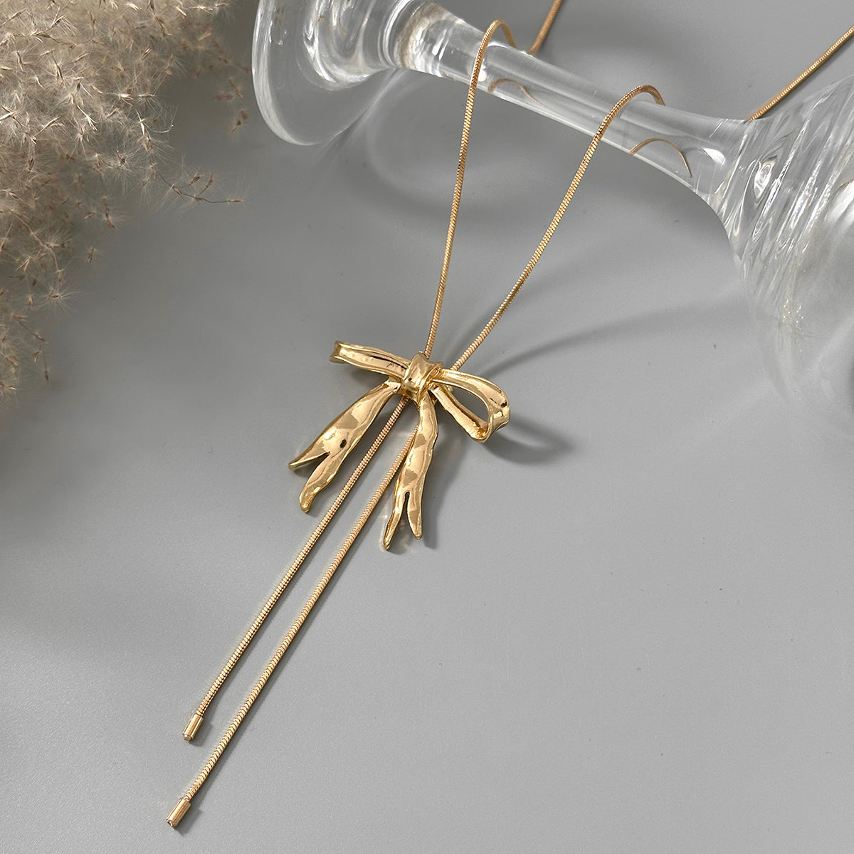Goldtone Bow Tassel Pendant Necklace, vintage-inspired design, side view