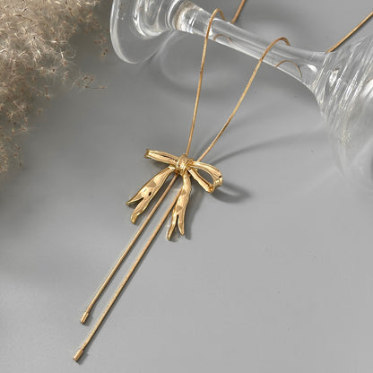 Goldtone Bow Tassel Pendant Necklace, vintage-inspired design, side view