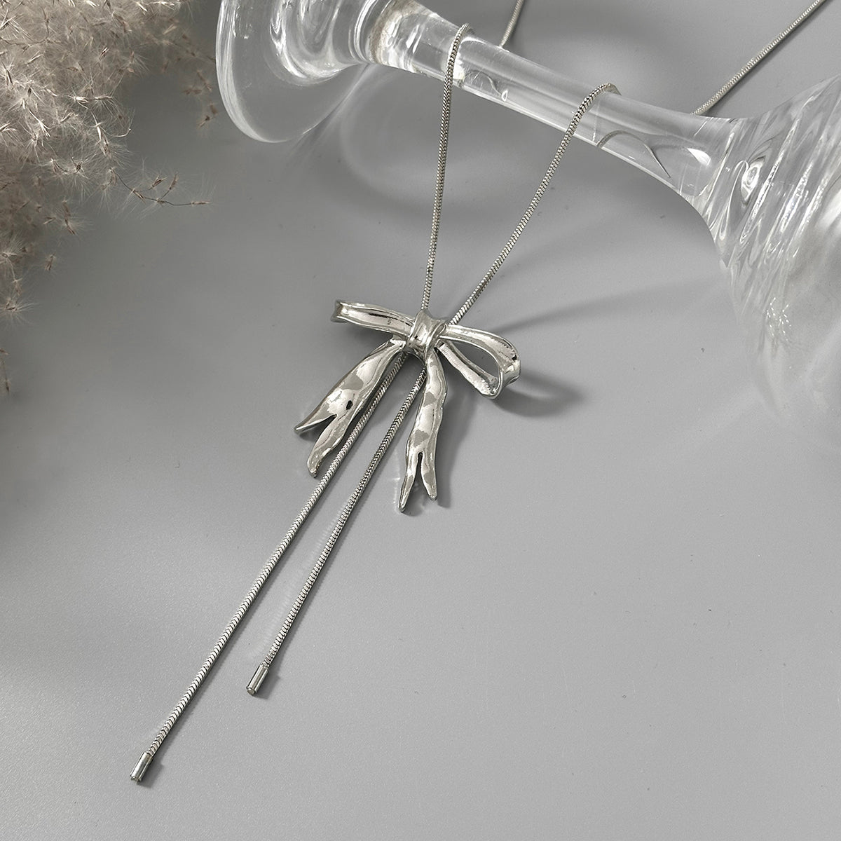 Silvertone Bow Tassel Pendant Necklace, vintage-inspired design, side view