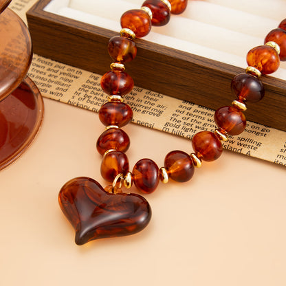 Amber Resin and Goldtone Bead Chain Heart Pendant Necklace, vintage-inspired design, side view