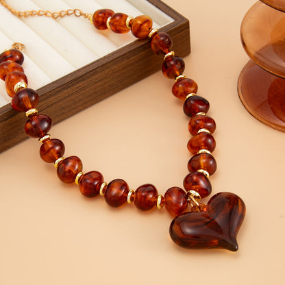 Amber Resin and Goldtone Bead Chain Heart Pendant Necklace, vintage-inspired design, detail close-up
