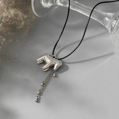 Black Polyster and Silvertone Horse Tassel Pendant Necklace, dainty minimalist design, side view