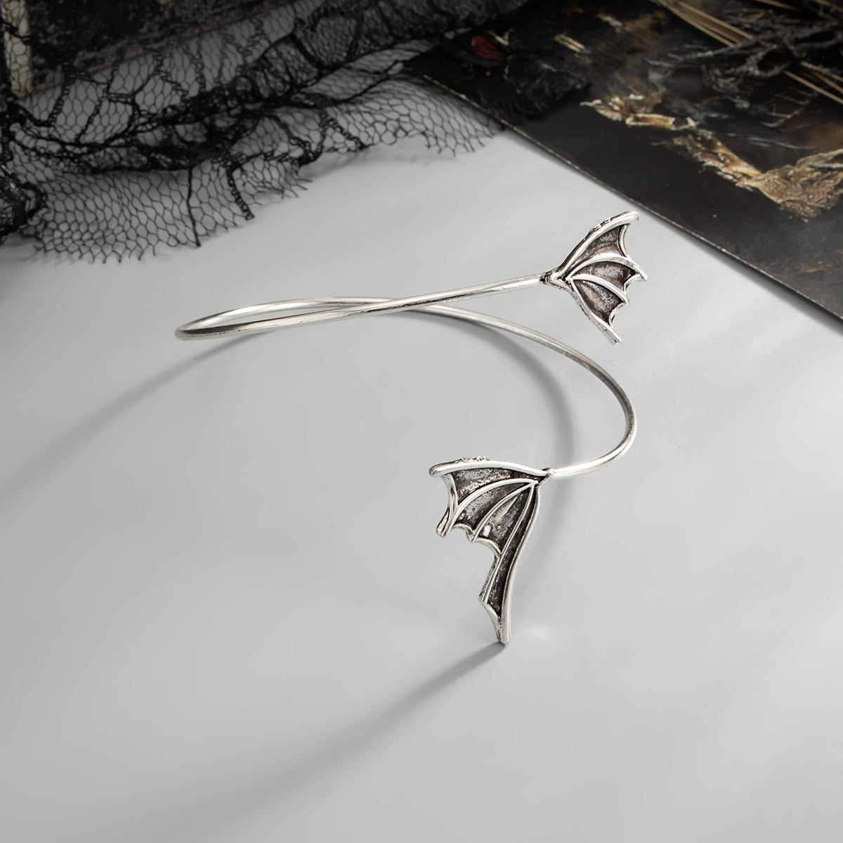 Silvertone Dual Bat Wing Bypass Arm Cuff, botanical inspired, detail close-up
