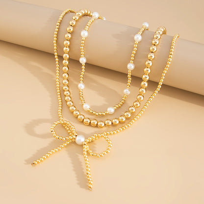 Pearl and Goldtone Beads Chain Bow Pendant Necklace Set, gold pendant necklace for women, everyday style, side view