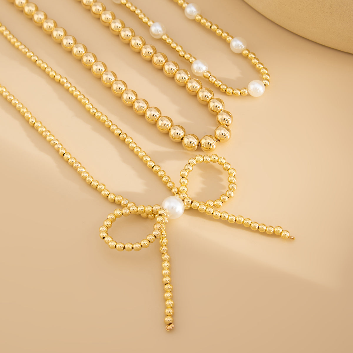 Pearl and Goldtone Beads Chain Bow Pendant Necklace Set, gold pendant necklace for women, everyday style, detail close-up