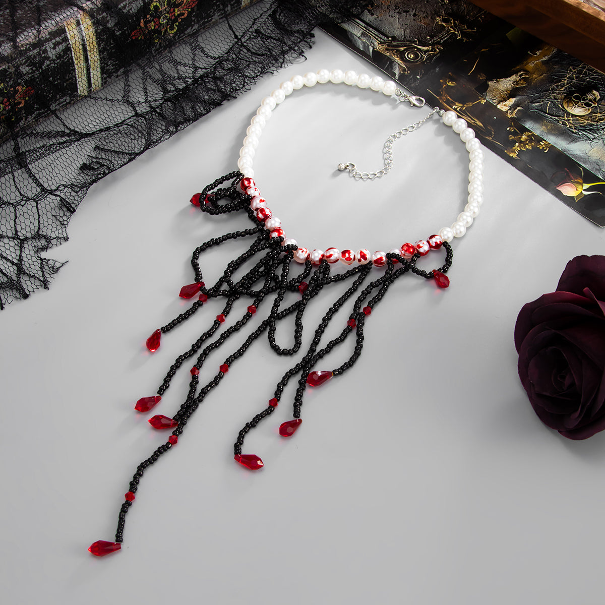 Black Acrylic and Enamel Pearl Silvertone Tassel Necklace, botanical inspired, side view