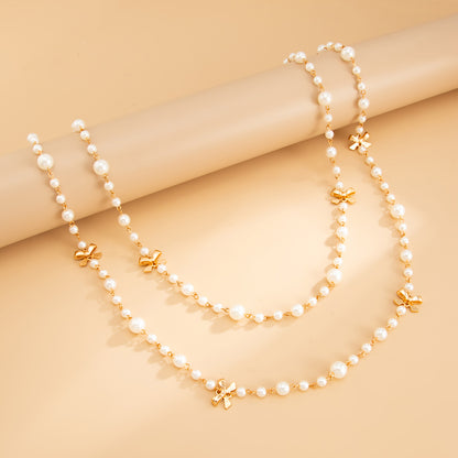 Pearl and Goldtone Bow Station Long Necklace Set, gold pendant necklace for women, dainty minimalist design, side view