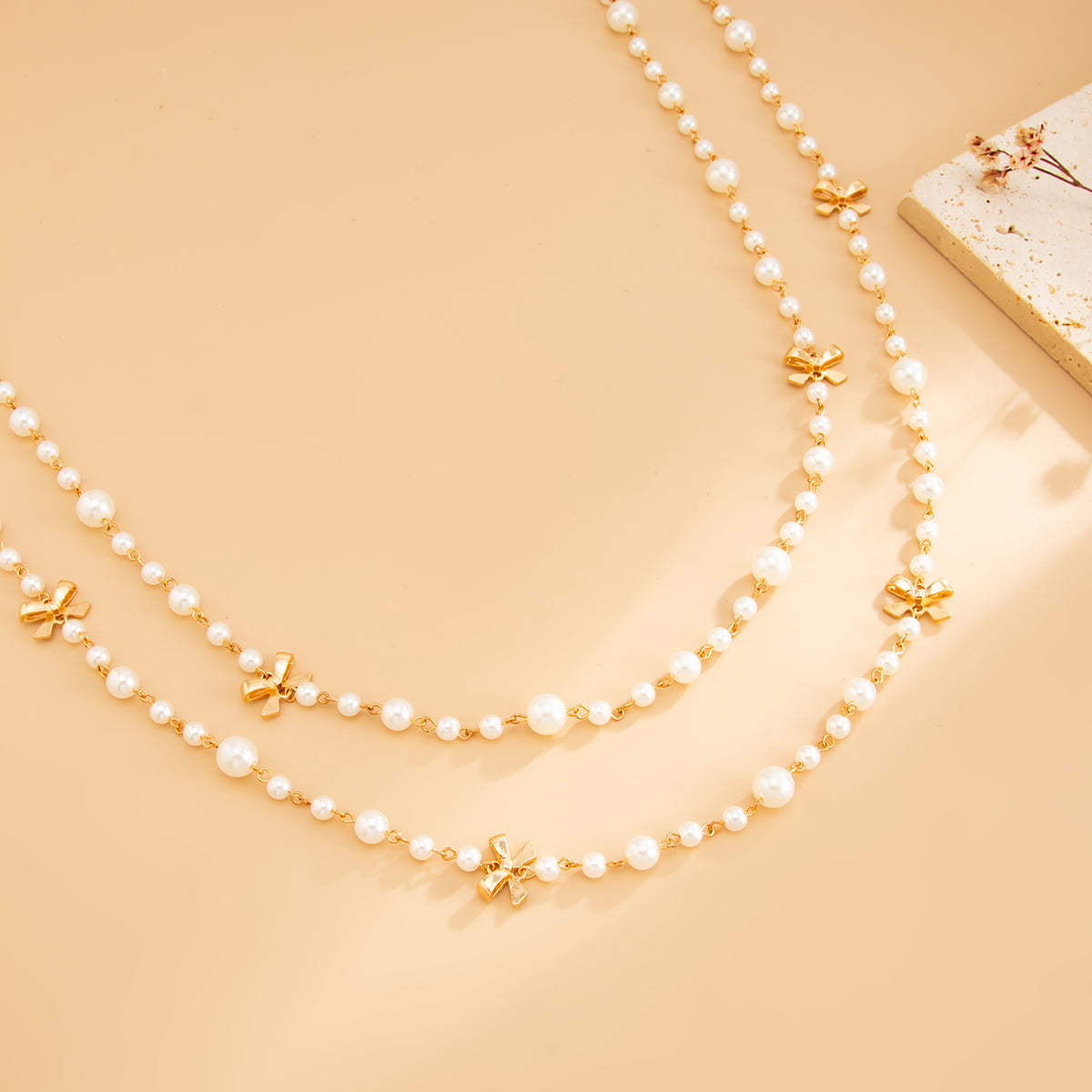 Pearl and Goldtone Bow Station Long Necklace Set, gold pendant necklace for women, dainty minimalist design, detail close-up