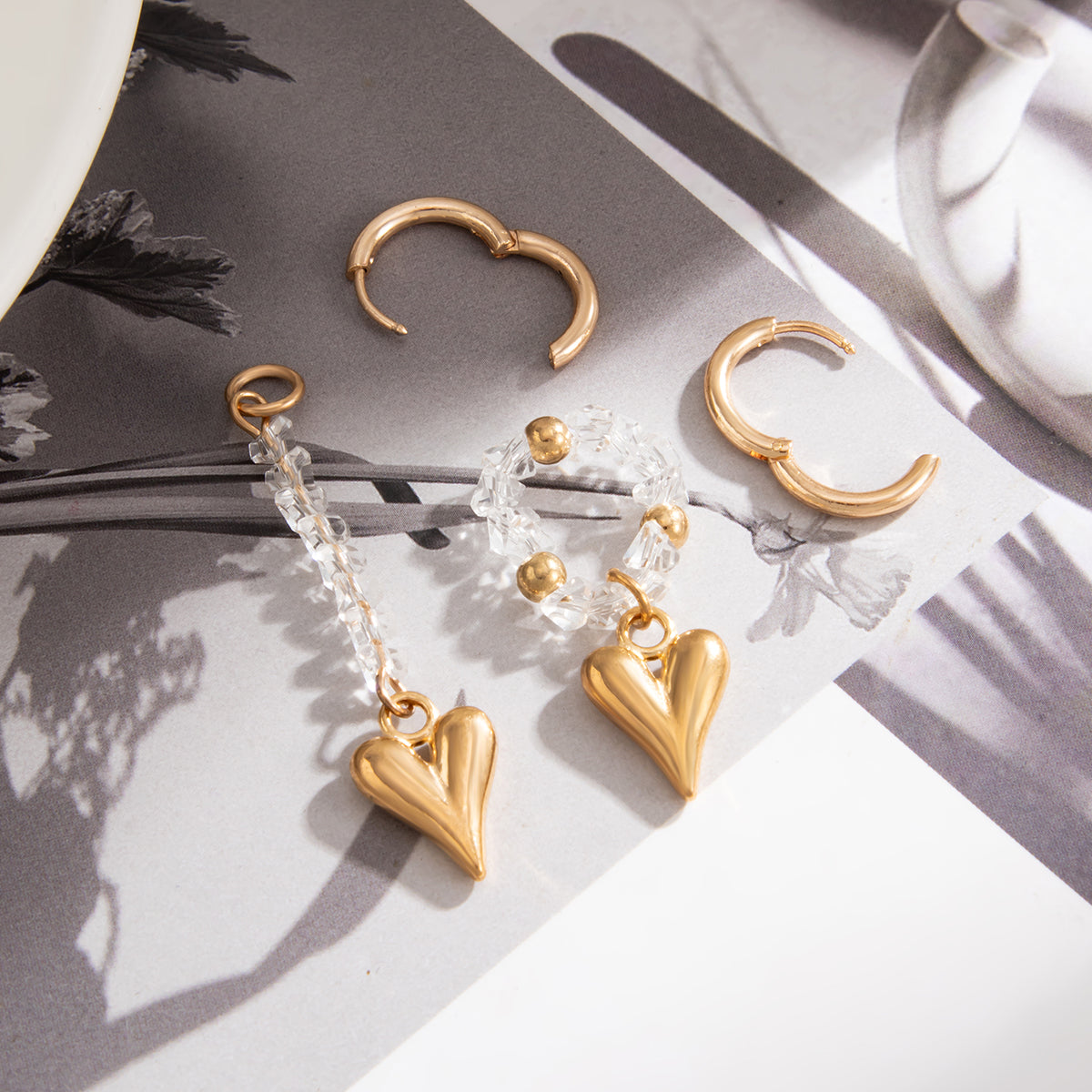 Clear Acrylic and Goldtone Mismatching Heart Dangle Earrings, dainty minimalist design, detail close-up