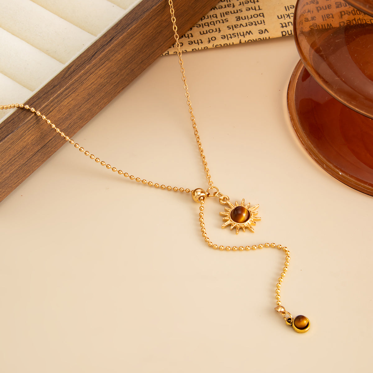 Tiger's Eye‌ and Goldtone Sun Lariat Necklace, vintage-inspired design, detail close-up
