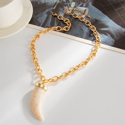 White Resin and Goldtone Wolf Tooth Pendant Necklace, dainty minimalist design, side view