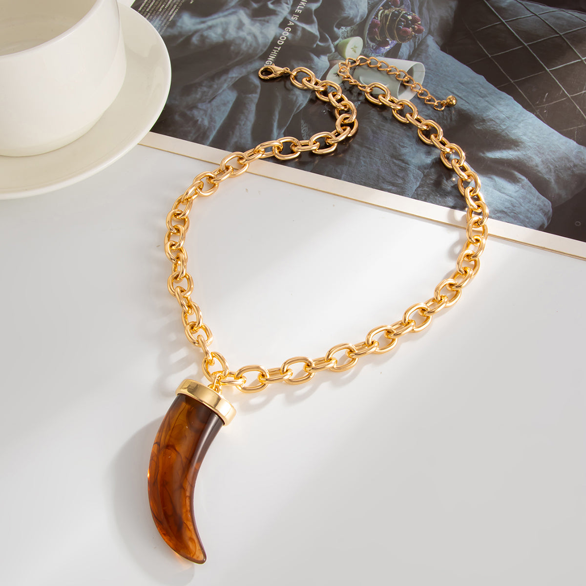 Red Resin and Goldtone Wolf Tooth Pendant Necklace, botanical inspired, side view
