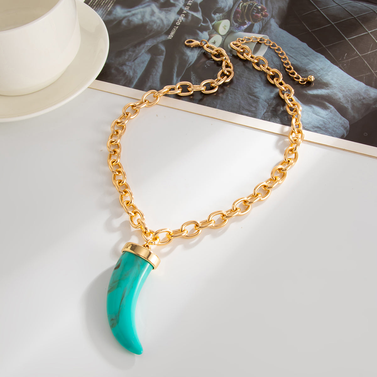 Blue Resin and Goldtone Wolf Tooth Pendant Necklace, everyday style, side view