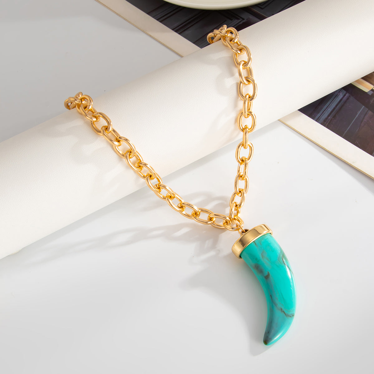 Blue Resin and Goldtone Wolf Tooth Pendant Necklace, everyday style, detail close-up