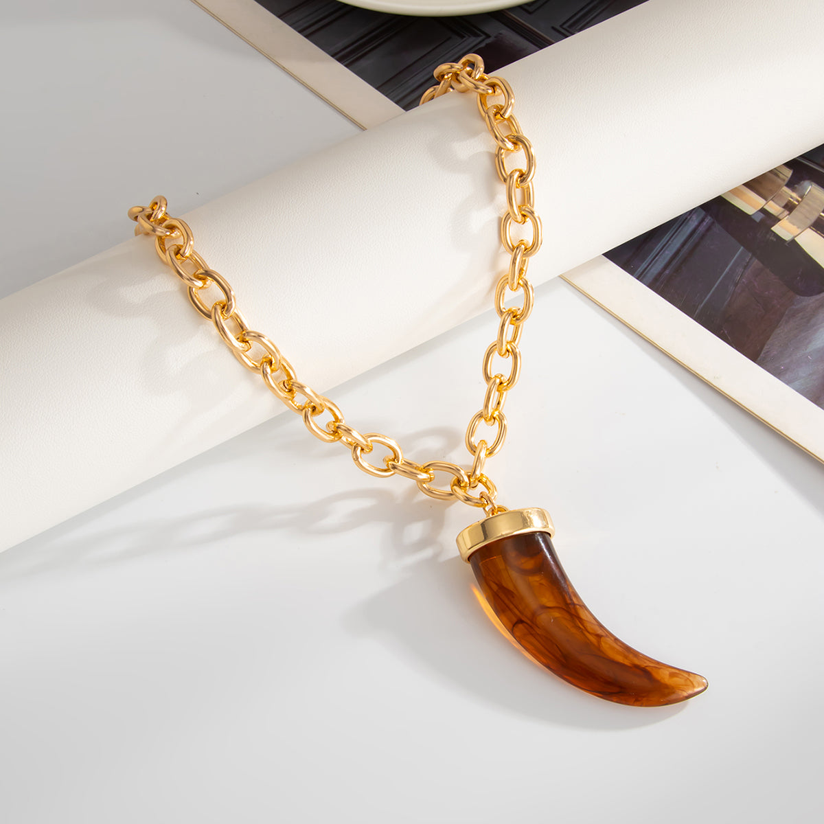 Red Resin and Goldtone Wolf Tooth Pendant Necklace, botanical inspired, detail close-up