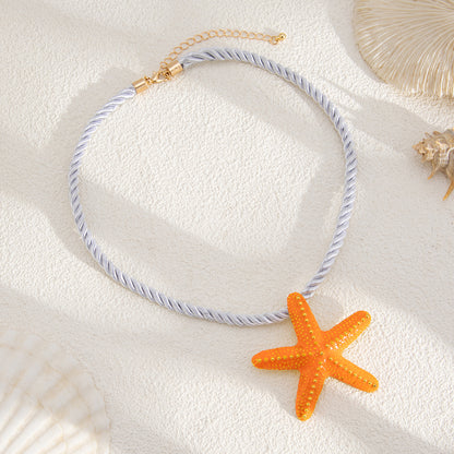 Thick Polyster Cord and Orange Enamel Goldtone Starfish Statement Necklace, dainty minimalist design, detail close-up