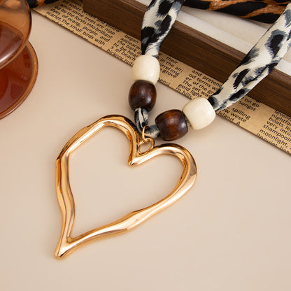Polyster and White Wood Goldtone Open Heart Pendant Necklace, botanical inspired, side view