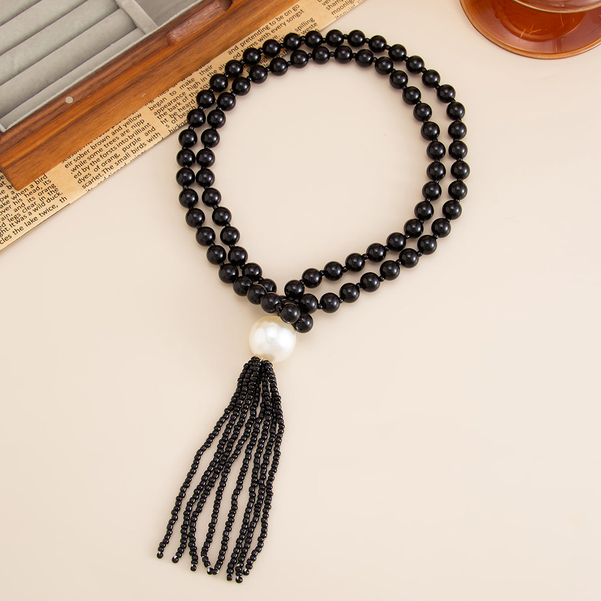 Black Resin and Pearl Big Ball Tassel Necklace, dainty minimalist design, side view