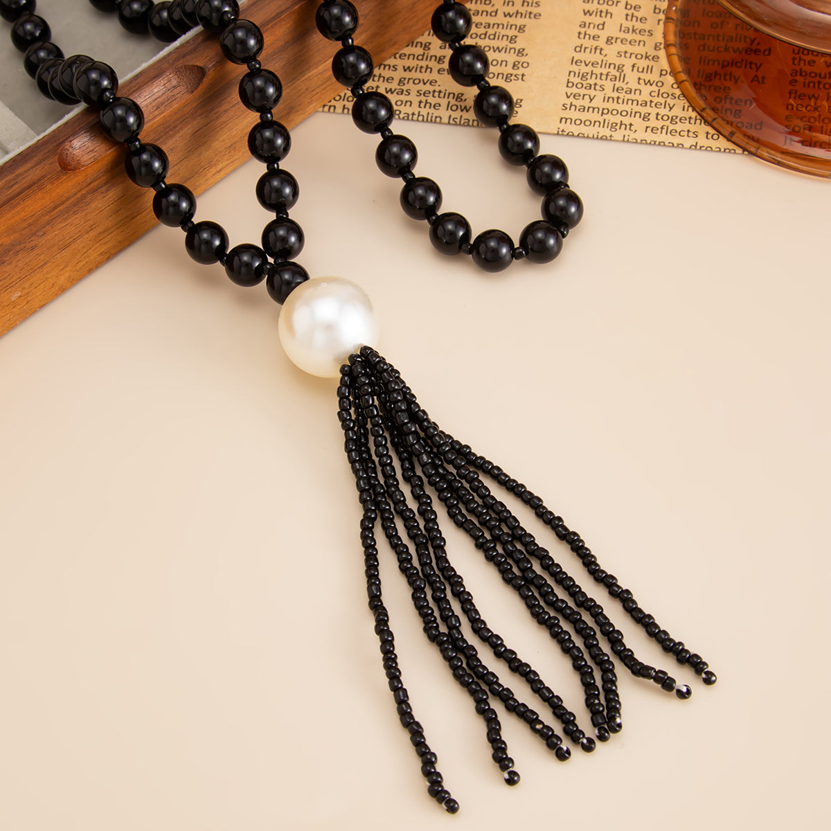 Black Resin and Pearl Big Ball Tassel Necklace, dainty minimalist design, detail close-up