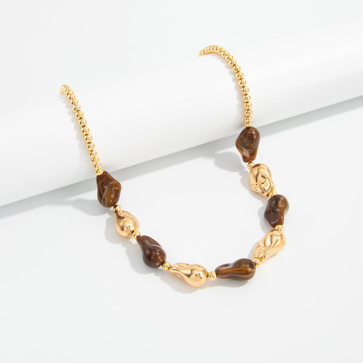 Brown Resin and Goldtone Irregular Drop Station Collar Necklace, botanical inspired, side view