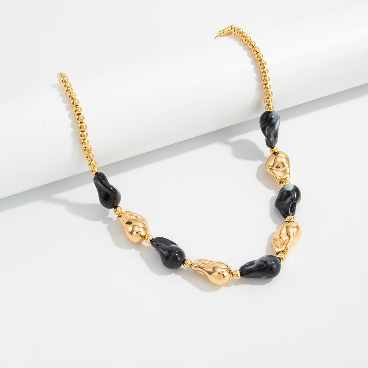 Black Resin and Goldtone Irregular Drop Station Collar Necklace, everyday style, lifestyle look