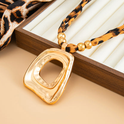 Polyster and Goldtone Leopard Print Open Trapezium Pendant Necklace, dainty minimalist design, detail close-up