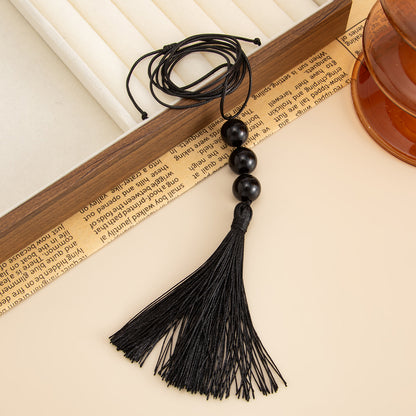 Black Resin and Polyster Tassel Necklace, botanical inspired, side view