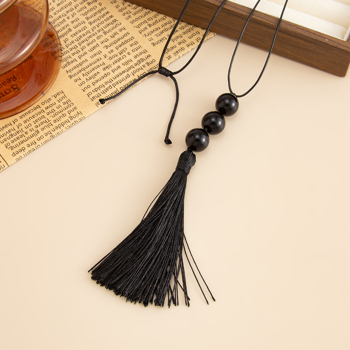 Black Resin and Polyster Tassel Necklace, botanical inspired, detail close-up