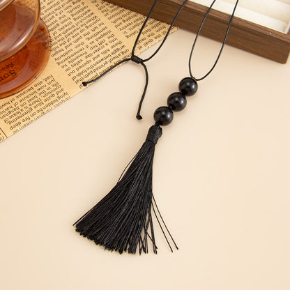 Black Resin and Polyster Tassel Necklace, botanical inspired, detail close-up