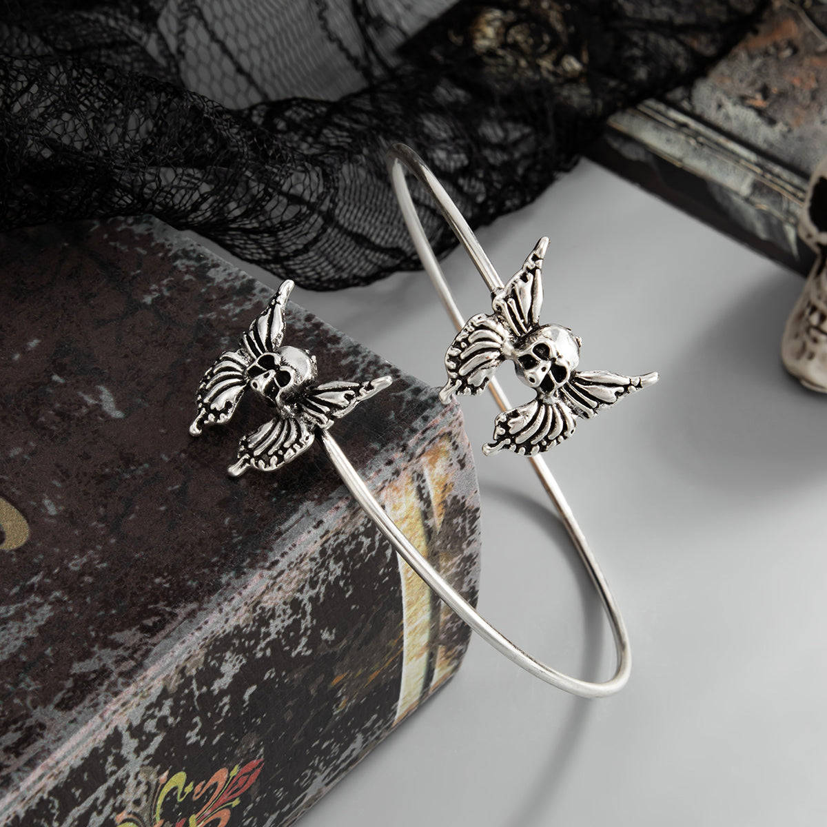 Silvertone Dual-Skull-Butterflies Bypass Arm Cuff, everyday style, detail close-up