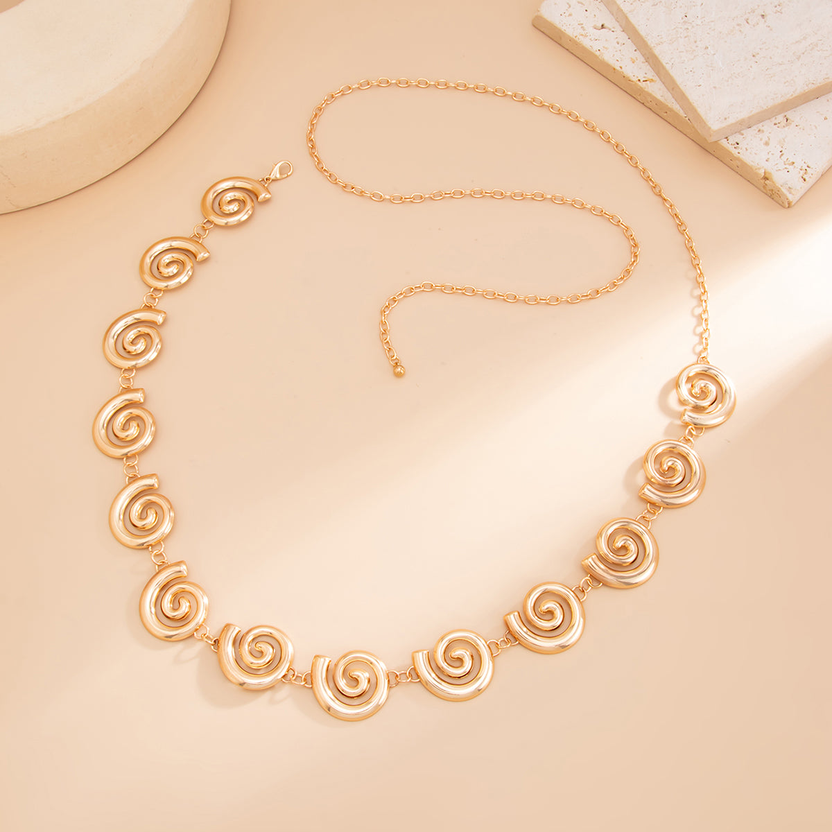 Goldtone Swirl Charm Waist Chain, dainty minimalist design, detail close-up