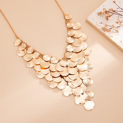 Goldtone Disc Tassel Statement Necklace, vintage-inspired design, detail close-up