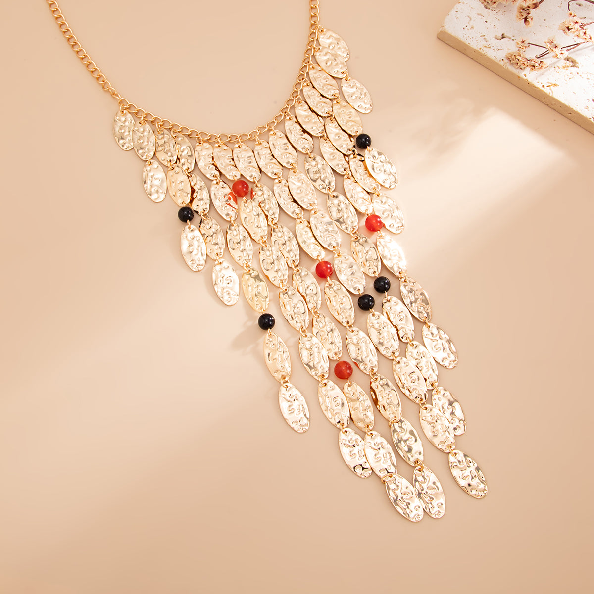 Resin and Goldtone Hammered Leaves Tassel Statement Necklace, dainty minimalist design, detail close-up