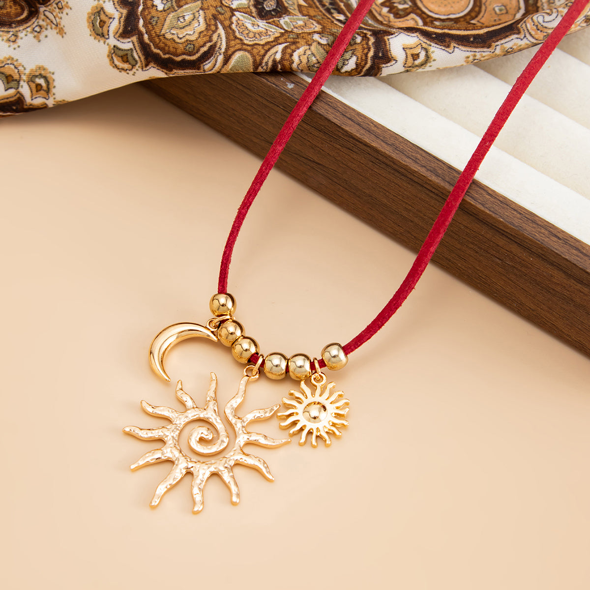 Red Polyster and Goldtone Sun Moon Pendant Necklace, vintage-inspired design, side view