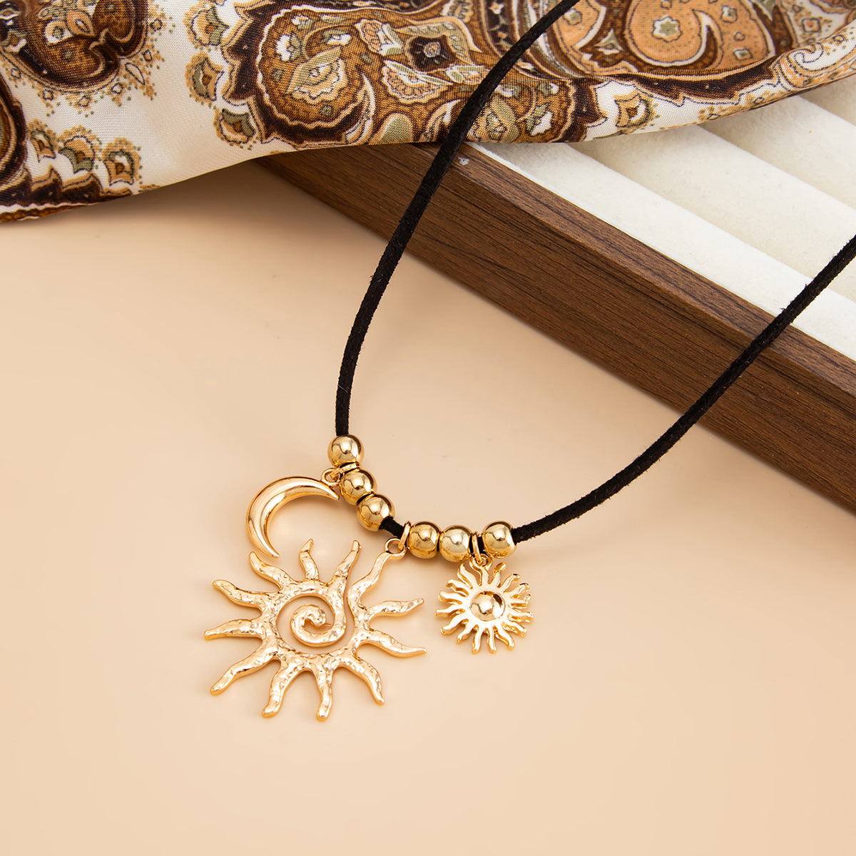Black Polyster and Goldtone Sun Moon Pendant Necklace, vintage-inspired design, detail close-up