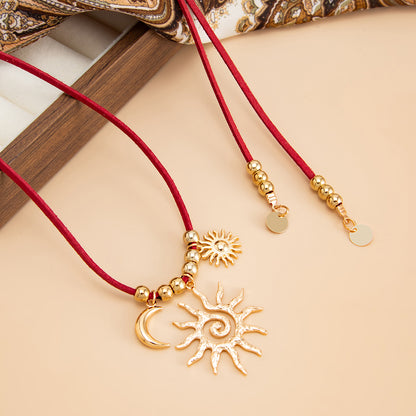 Red Polyster and Goldtone Sun Moon Pendant Necklace, vintage-inspired design, detail close-up