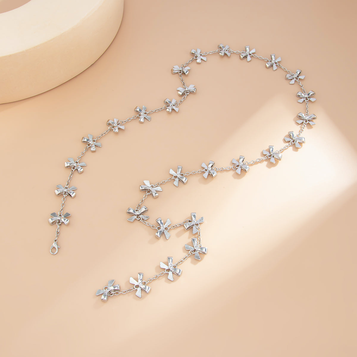 Silvertone Bow Station Lariat Necklace, botanical inspired, detail close-up