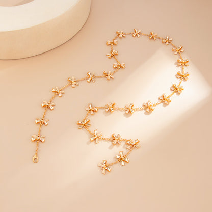 Goldtone Bow Station Lariat Necklace, botanical inspired, side view