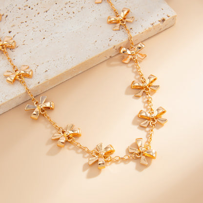 Goldtone Bow Station Lariat Necklace, botanical inspired, detail close-up