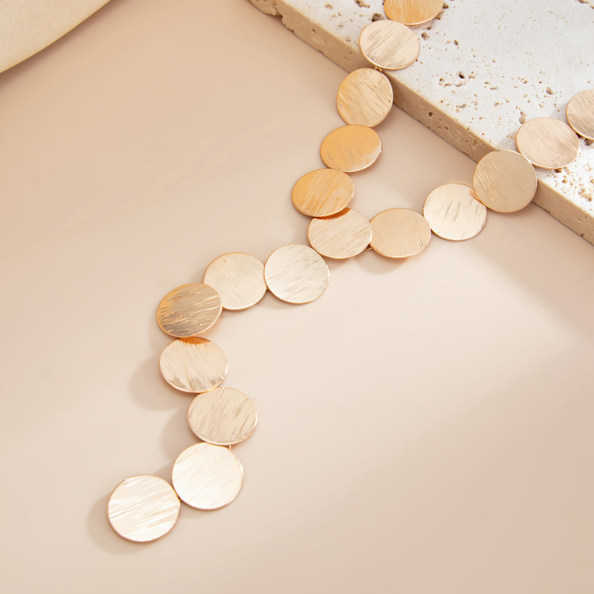 Goldtone Disc Statement Y-Necklace, botanical inspired, detail close-up
