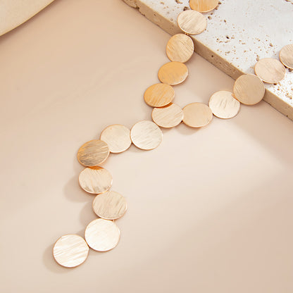 Goldtone Disc Statement Y-Necklace, botanical inspired, detail close-up