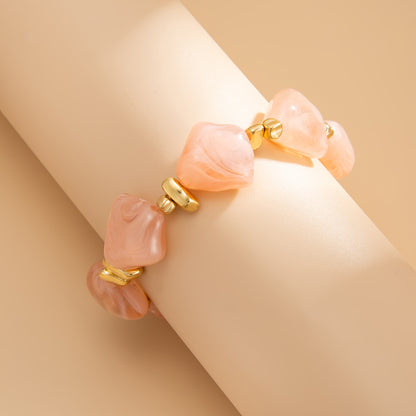 Pink Resin and Goldtone Beads Rhombus Station Stretch Bracelet, vintage-inspired design, detail close-up