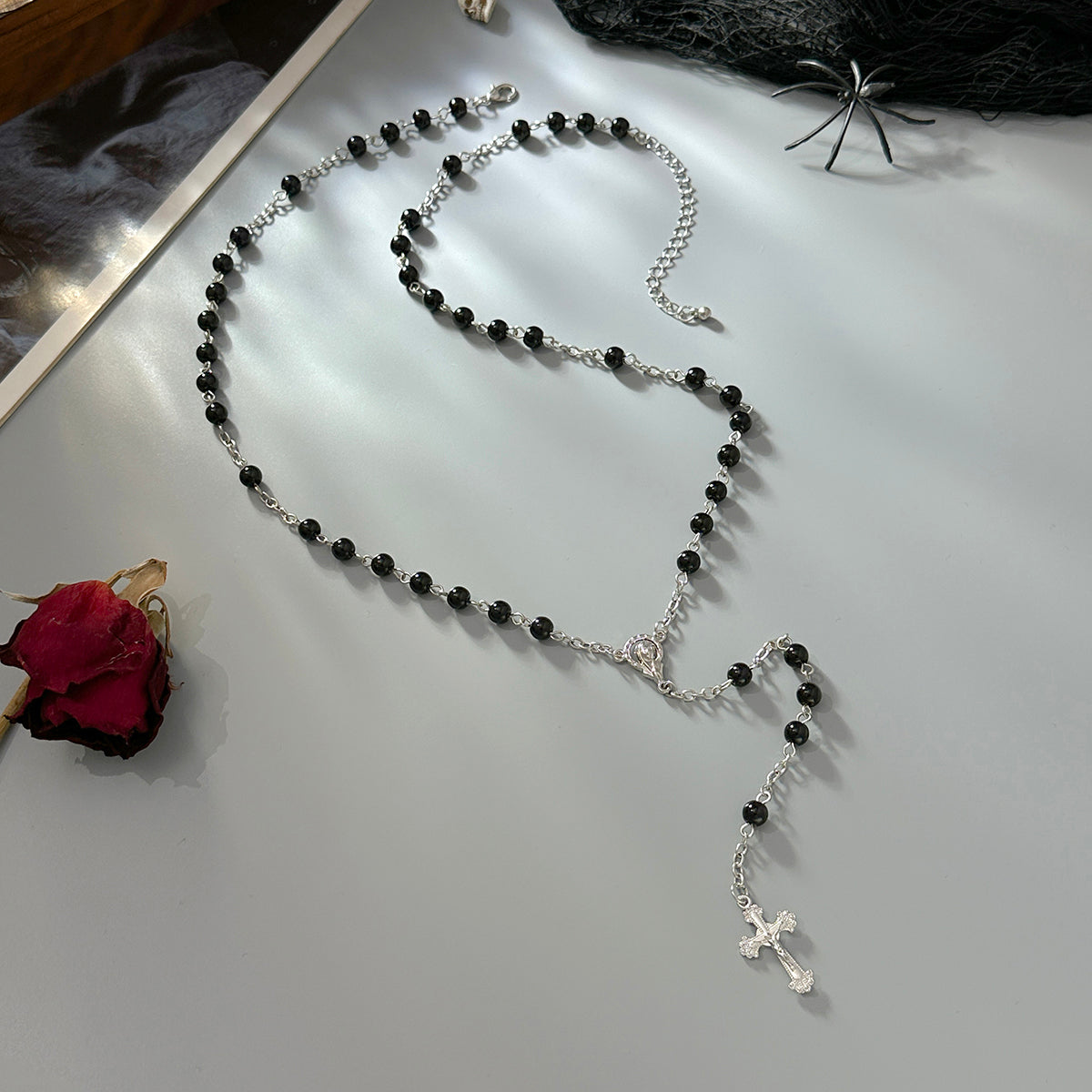 Black Acrylic and Silvertone Cross Drop Necklace, botanical inspired, side view