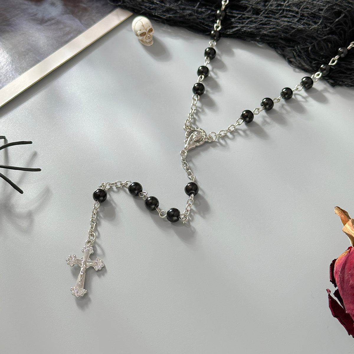 Black Acrylic and Silvertone Cross Drop Necklace, botanical inspired, detail close-up