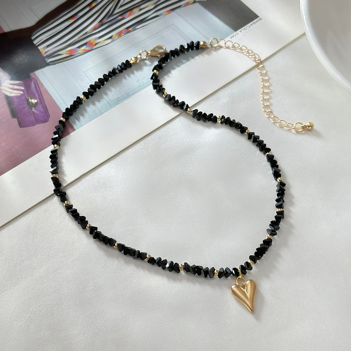 Black Acrylic and Goldtone Heart Pendant Necklace, everyday style, side view
