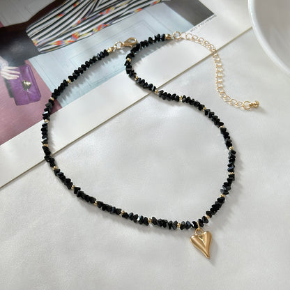 Black Acrylic and Goldtone Heart Pendant Necklace, everyday style, side view