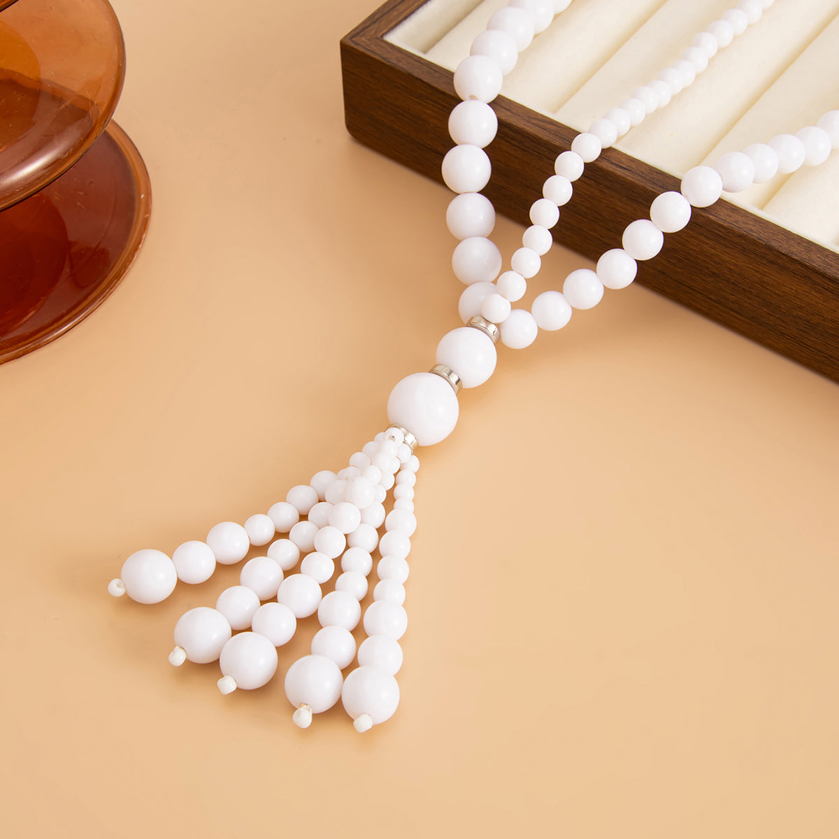 White Resin and Silvertone Graduated Bead Tassel Layered Necklace, vintage-inspired design, side view