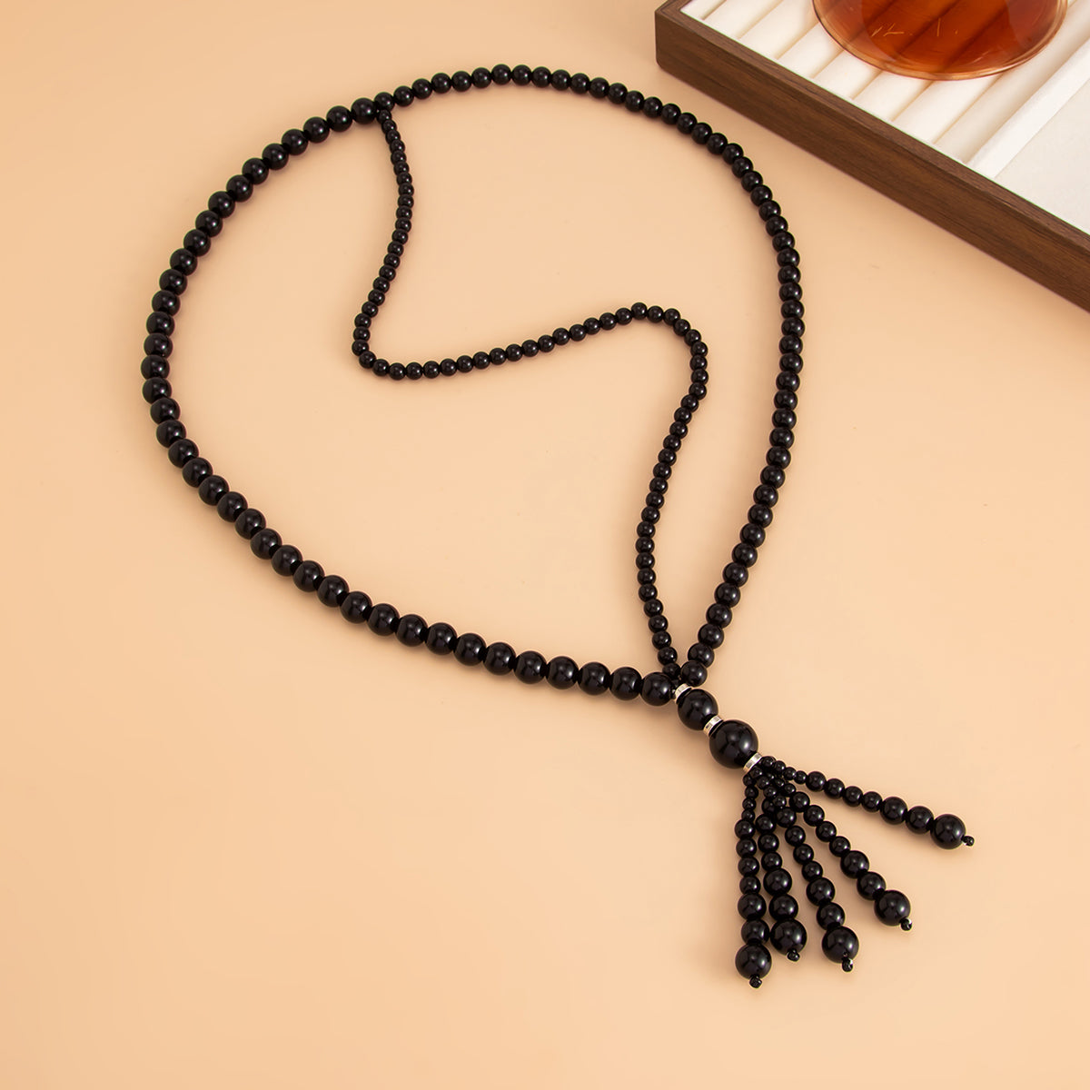 Black Resin and Silvertone Graduated Bead Tassel Layered Necklace, dainty minimalist design, detail close-up