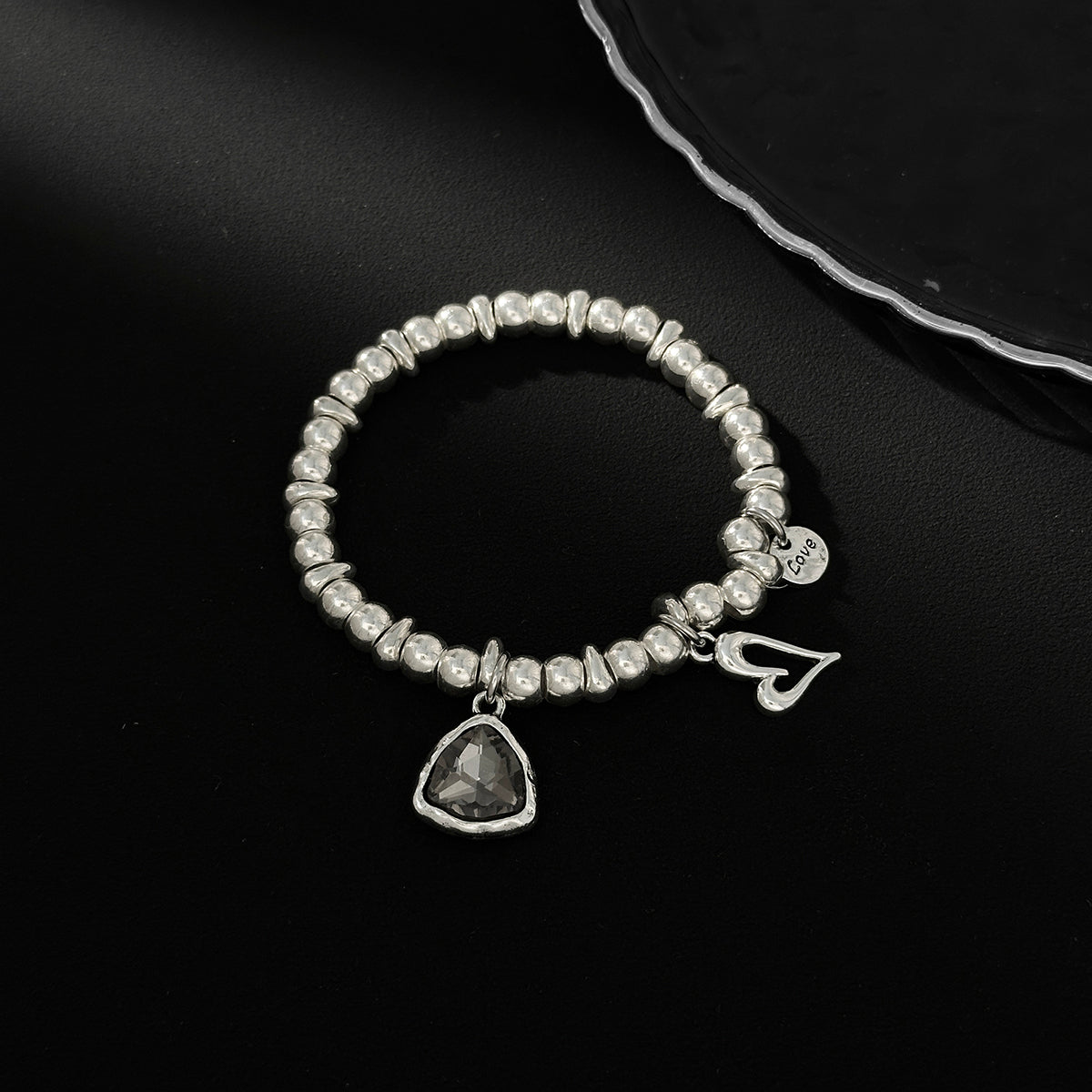 Crystal and Silvertone Open Heart Charm Stretch Bracelet, silver bracelet for women, vintage-inspired design, side view