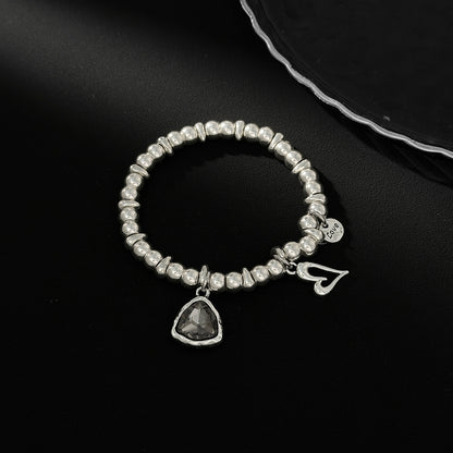 Crystal and Silvertone Open Heart Charm Stretch Bracelet, silver bracelet for women, vintage-inspired design, side view